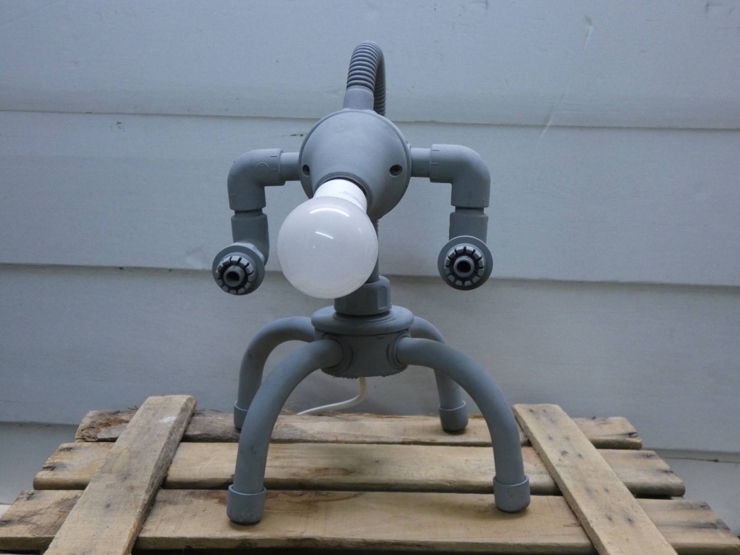 Escultura lámpara robot realizada con PVC, piezas de fontanería y electricidad, línea robot terminator  futurista efecto oxido. MEDIDAS: Ancho 25 cm X Alto 33 cm X Fondo 21 cm Bombilla incluida